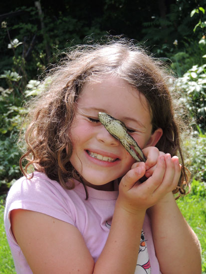 Ivy with frog jumping out of her hands
